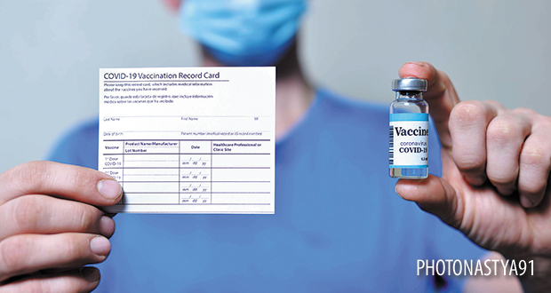 vaccination record card and vaccine vials