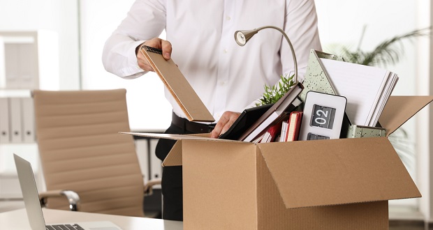 Resigning employee packing up desk