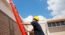 Worker climbing ladder (lisafx/Deposit Photos)