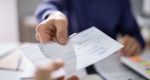 Employee being handed paycheck