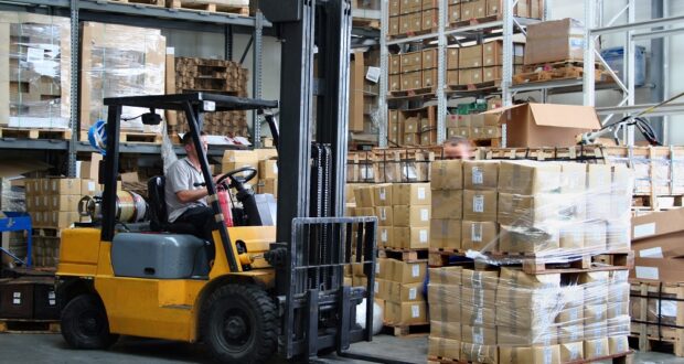 Man driving forklift in warehouse