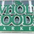 Close-up logo of Whole Foods Market at store entrance facade