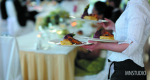 Waitress carrying plates