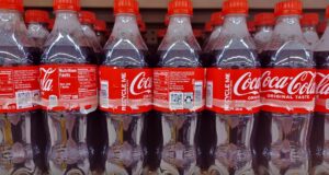 Coca Cola bottles on store shelf