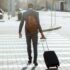 Worker crossing street with luggage for travel